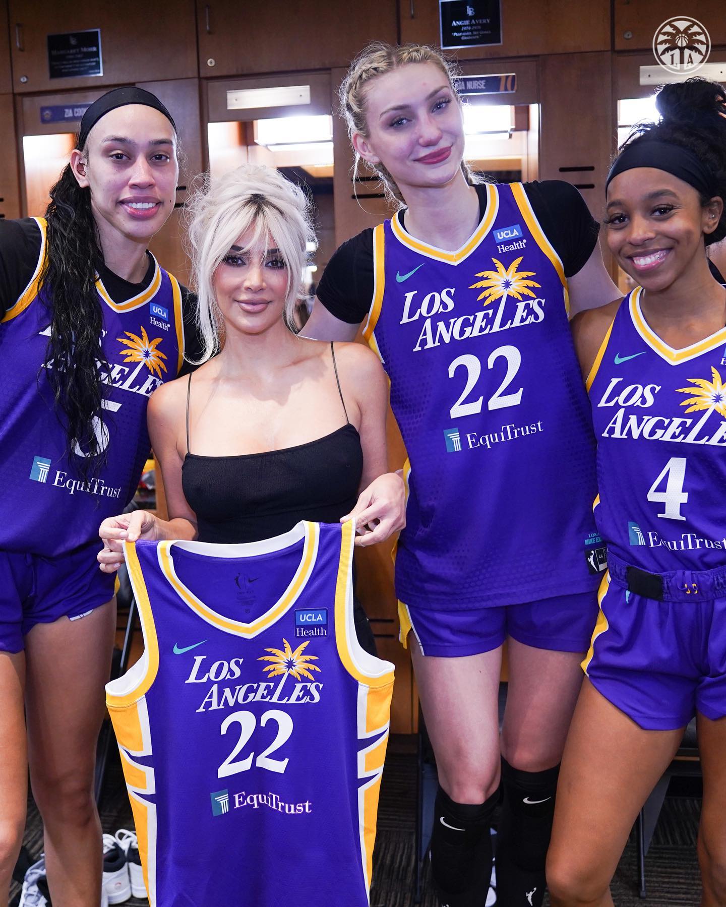 Kim showed off her basketball jersey while posing with the other LA Sparks players