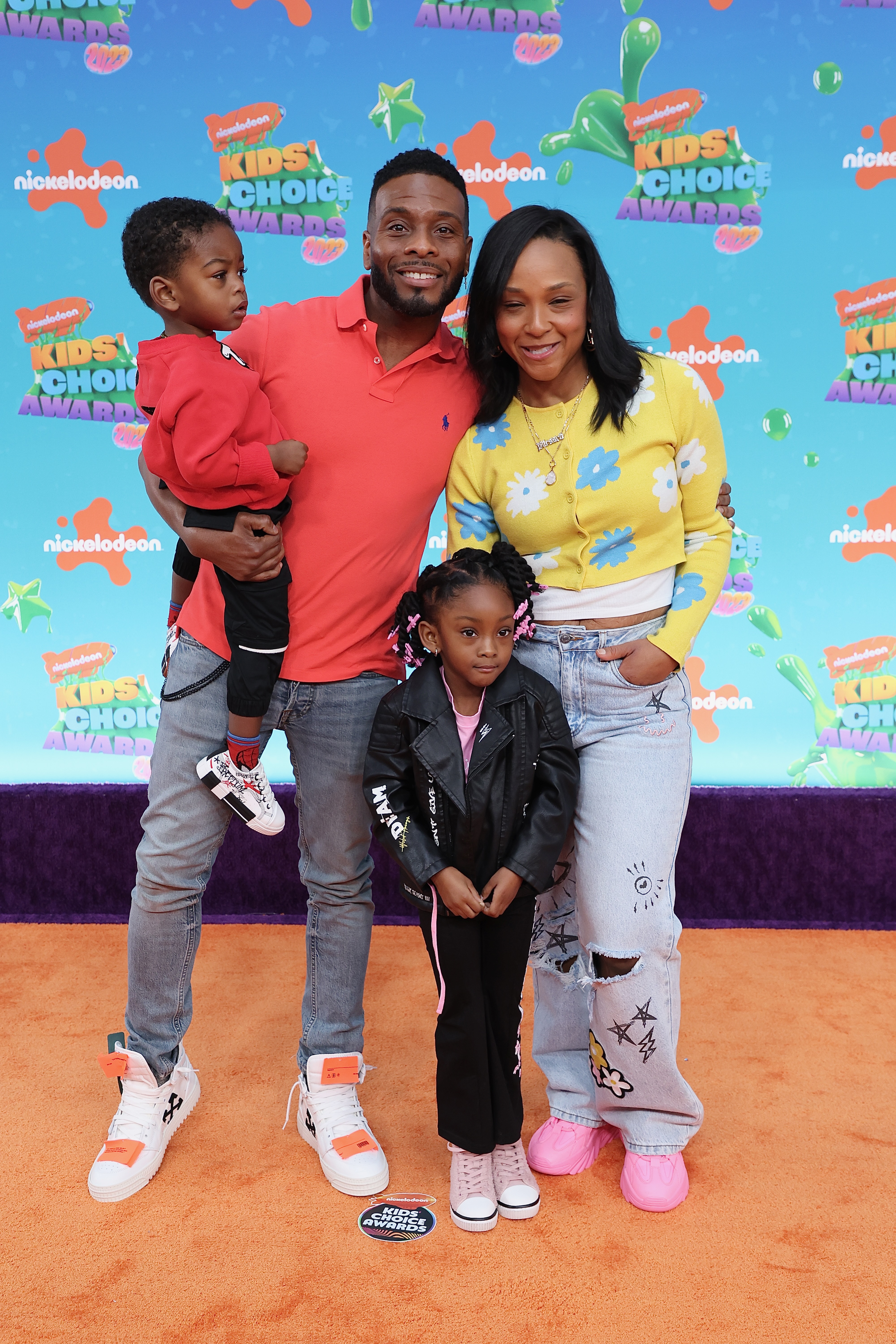 Kel posed with wife Asia Lee-Mitchell and their kids at an event in March 2023