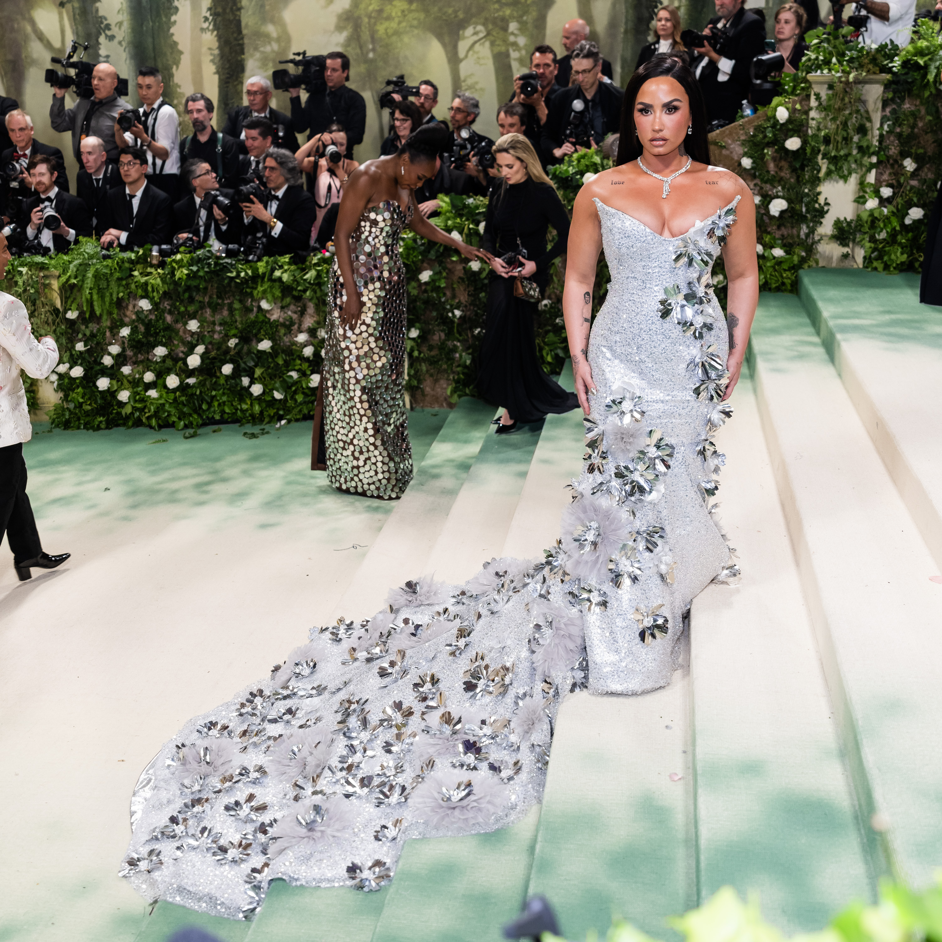 Demi's silver dress for the 2024 Met Gala event was covered in bejeweled hand-cut flowers