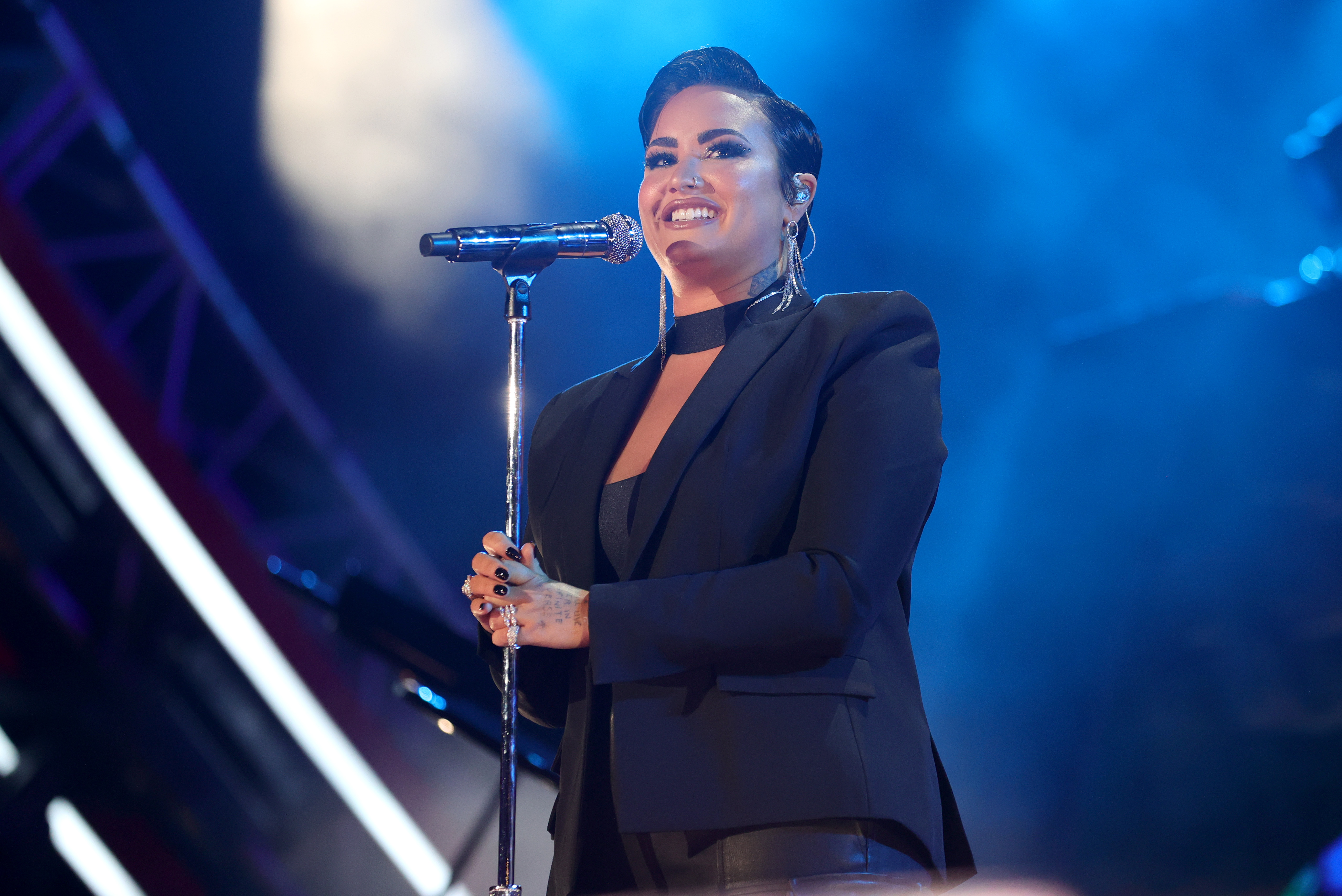 Demi pictured performing onstage at a concert in September 2021