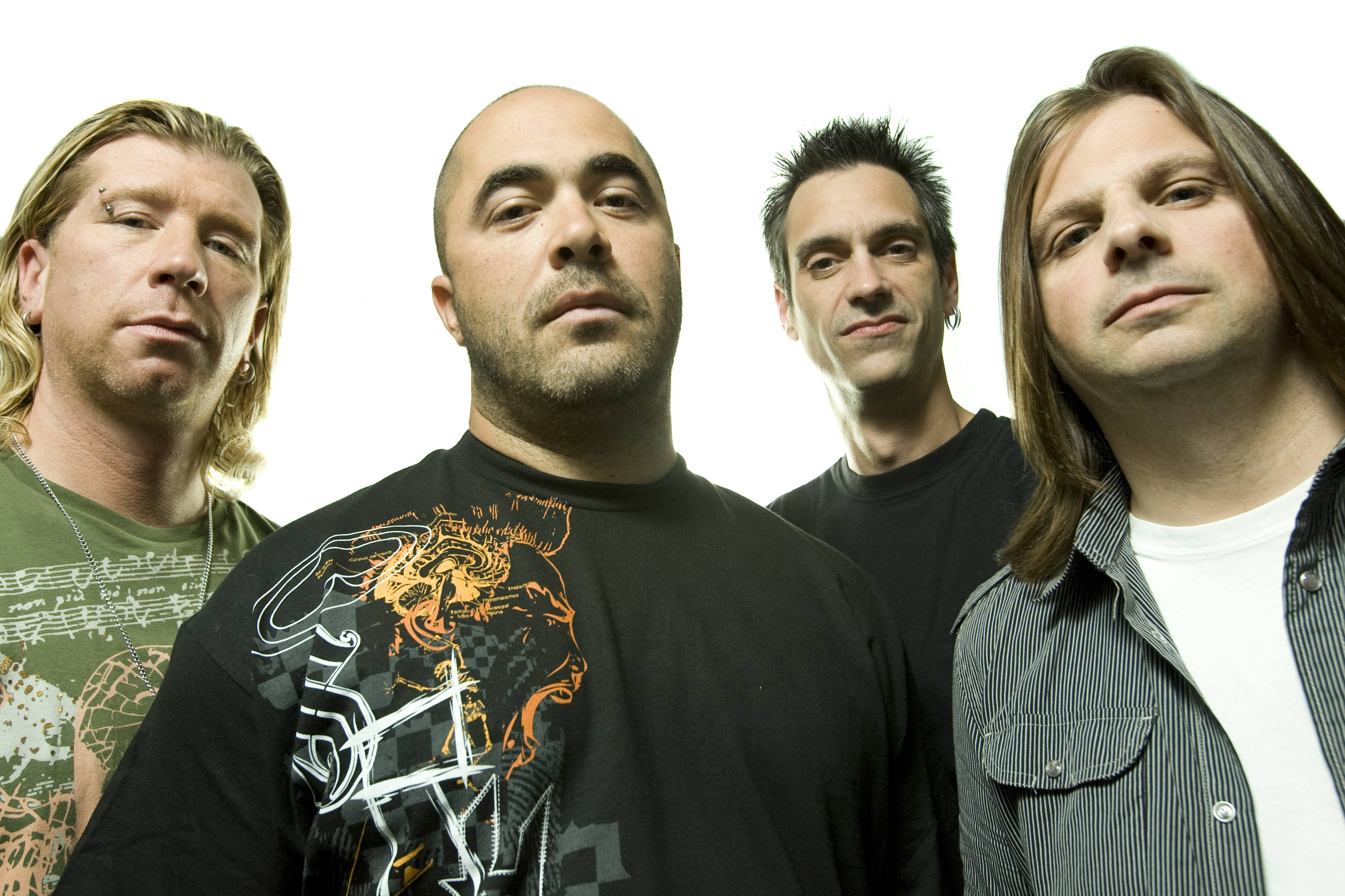 A group portrait of American rock band Staind. Left to right are Jon Wysocki, Aaron Lewis, Johnny April and Mike Mushok