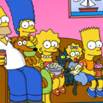 The Simpsons on their couch smiling