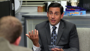 Steve Carell as Michael Scott at a desk talking on The Office