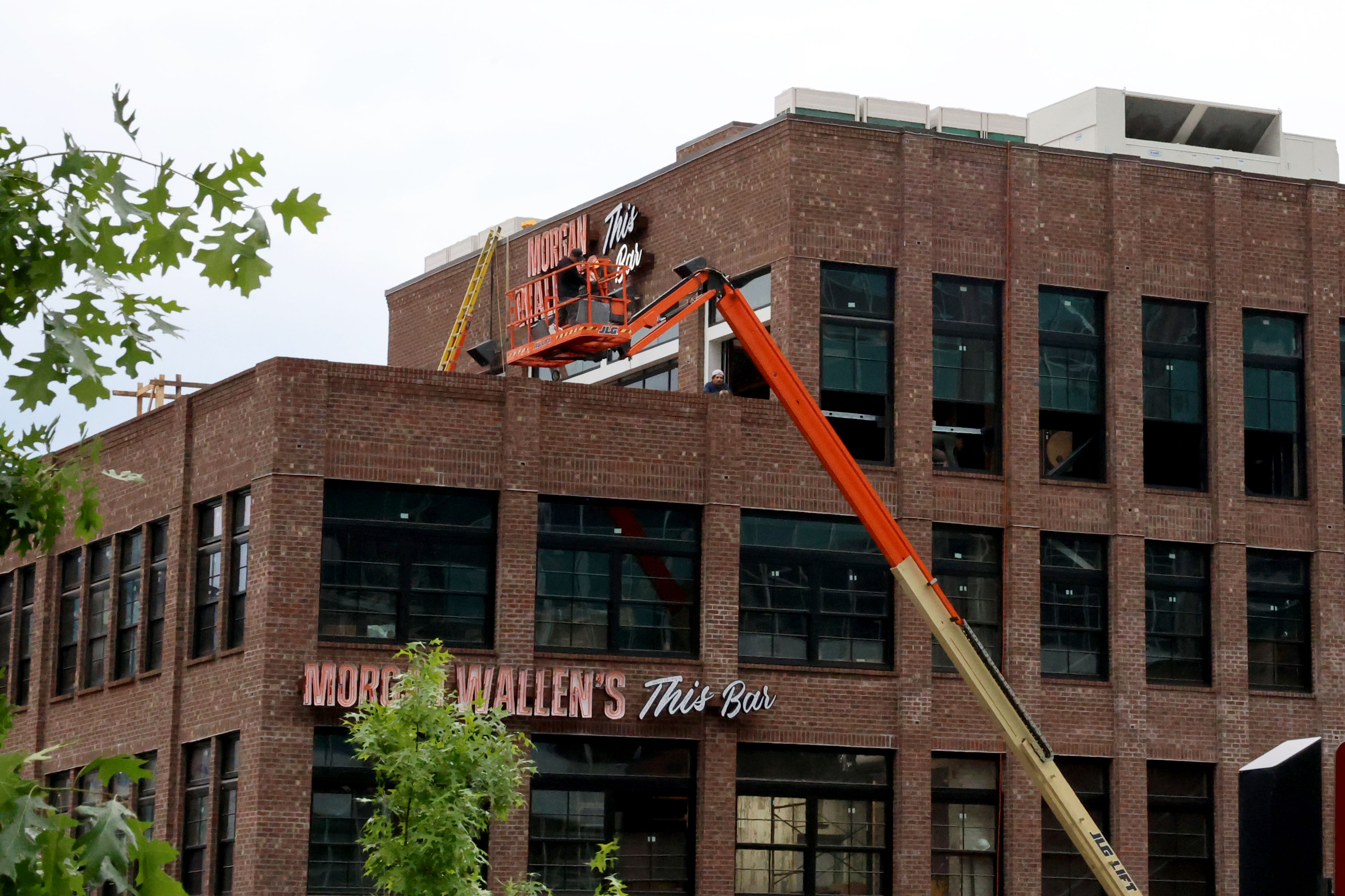 Workers appeared to be placing final touches on the sign in front of the building