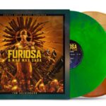 The cover of the Furiosa soundtrack with her in gold with a green and a brown vinyl record coming out of the side