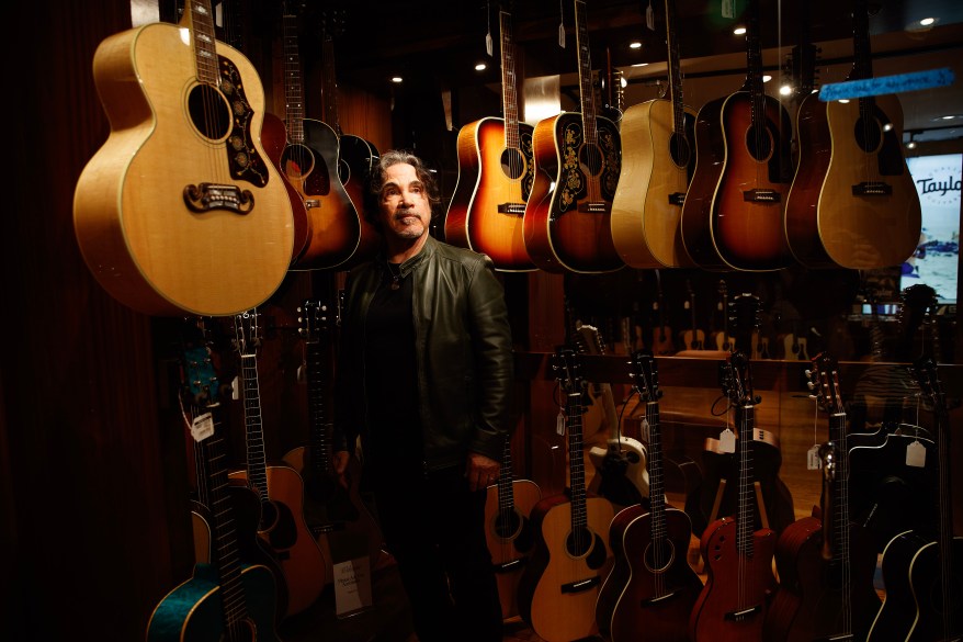 Oates checking out the guitars at Rudy's Music.