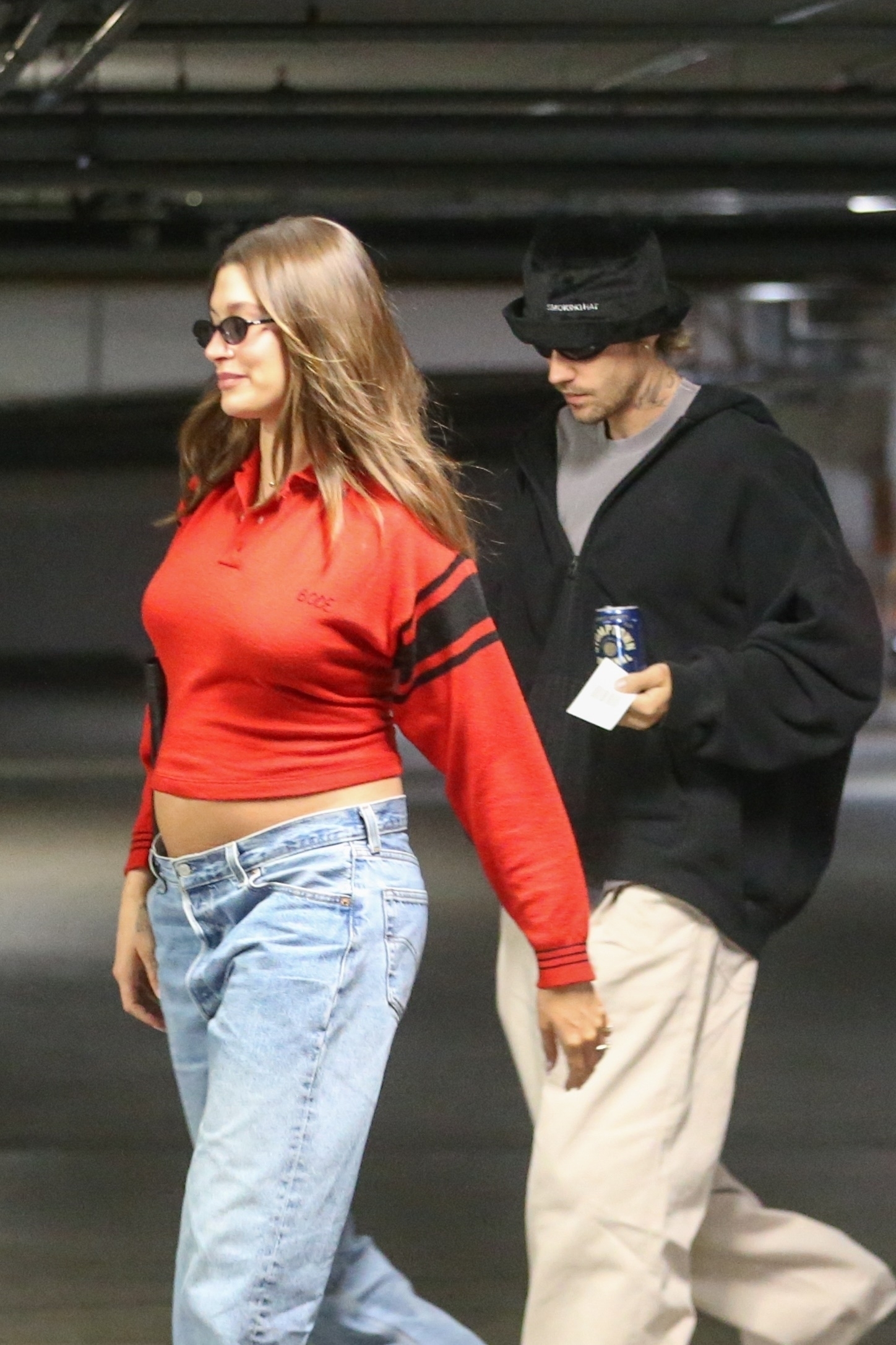 Hailey flashed her baby bump while wearing a red crop top with black stripes on the sleeves