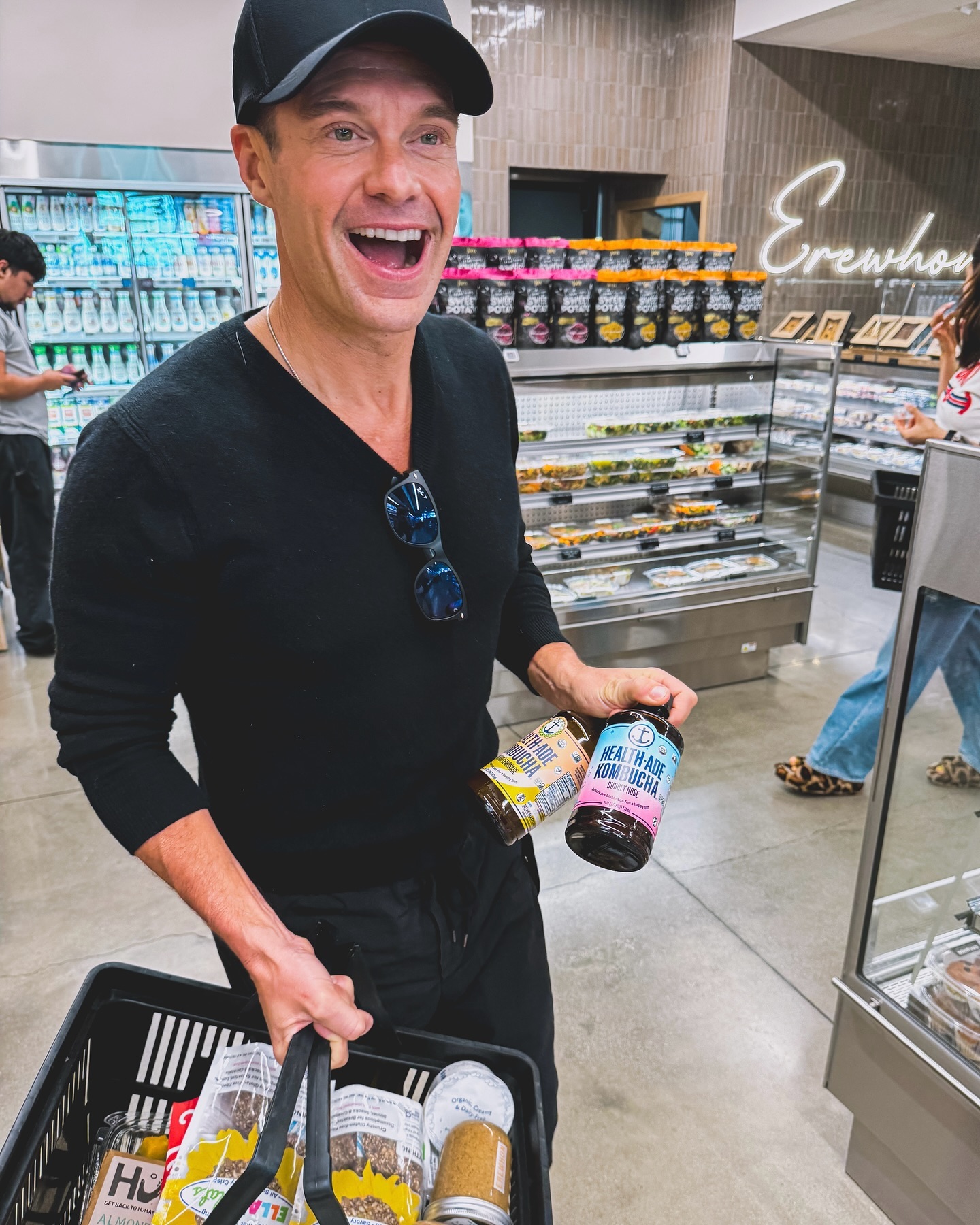 Ryan was all smiles while carrying two bottles of Health-Ade Kombucha tea