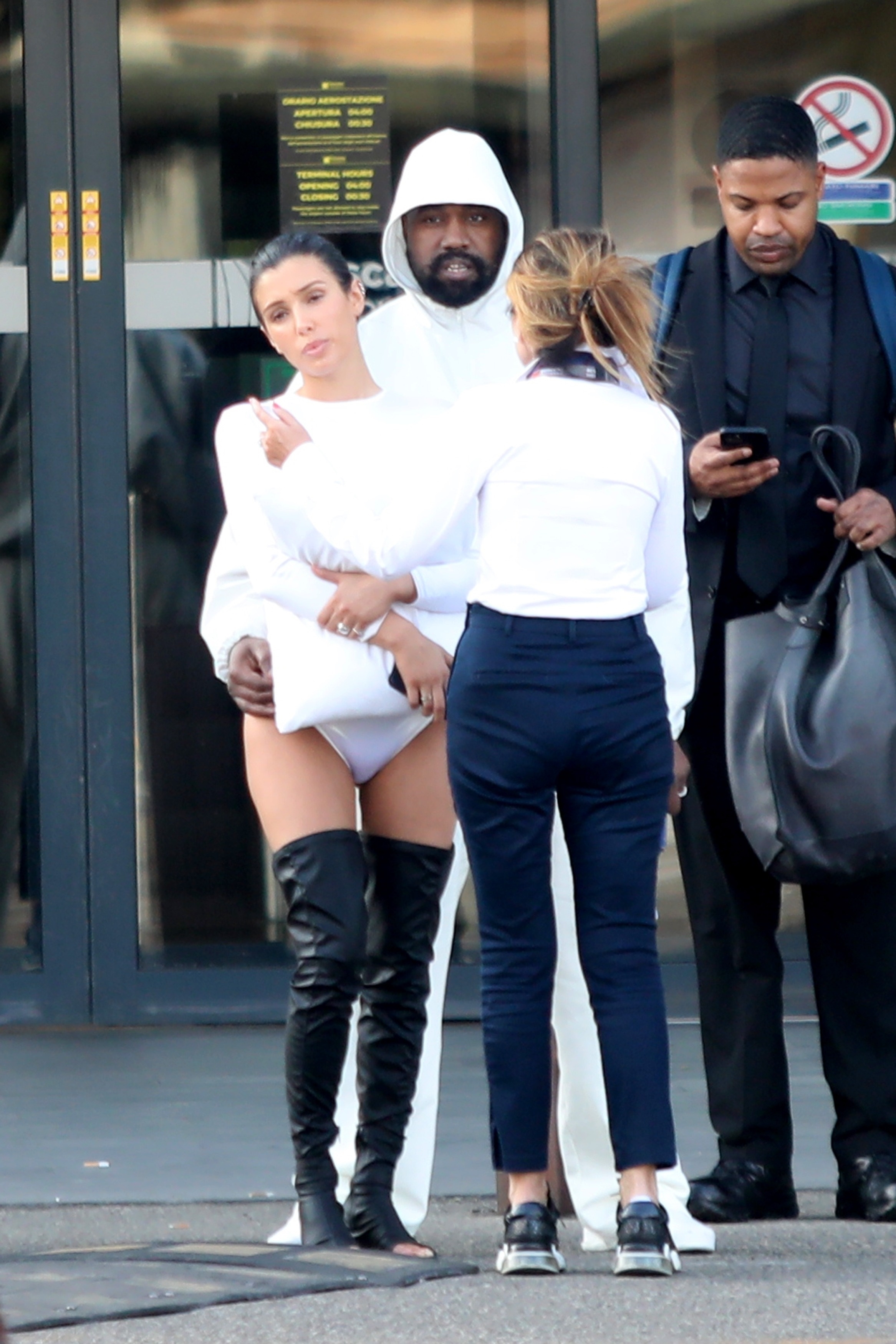 Meanwhile, Kanye chose to cover up in a white hoodie and pants