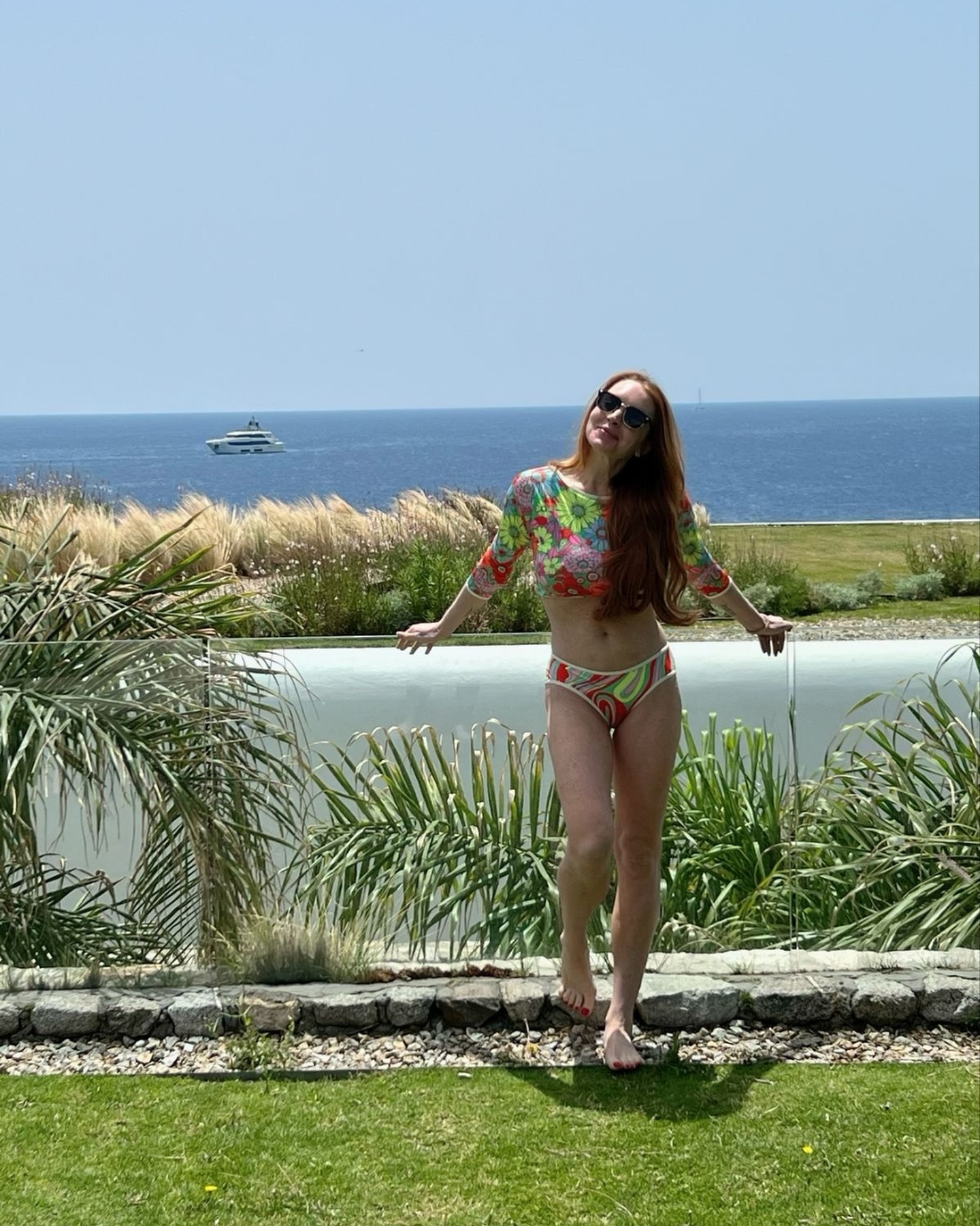 The Mean Girls star flaunted her slim figure and smiled in photos from a recent beach vacation