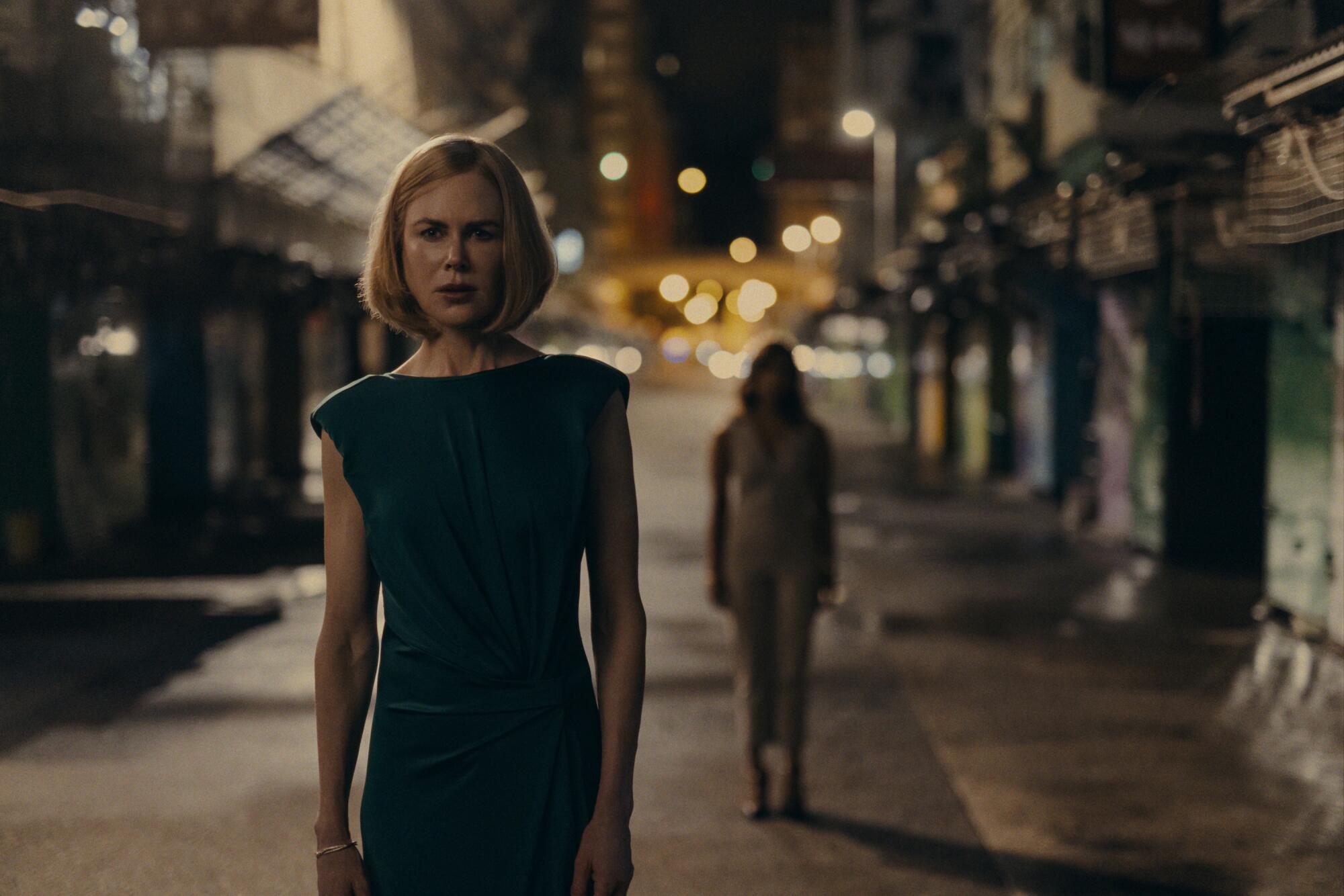 Nicole Kidman walks down a nighttime street in a scene from "Expats."