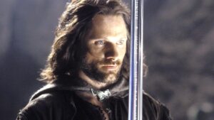 Viggo Mortensen as Aragorn holding his sword in The Lord of the Rings