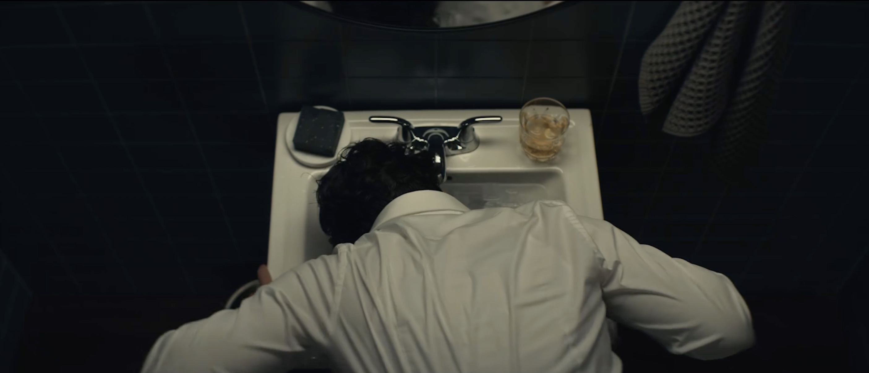 The video opens with a man dunking his face in a sink full of ice