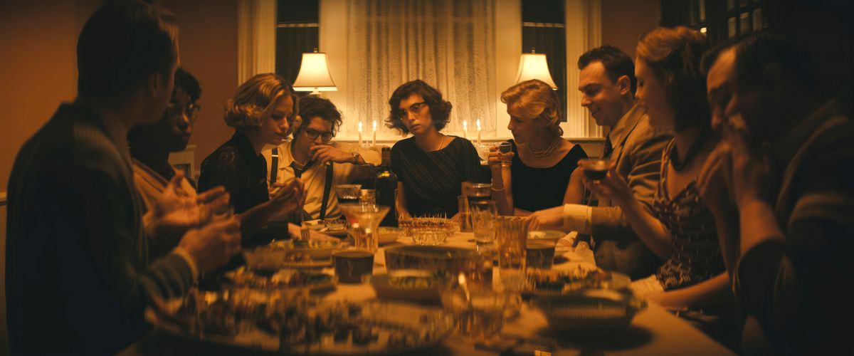 Maya Hawke as Flannery O’Connor, looking bored as hell in the middle of a dinner party