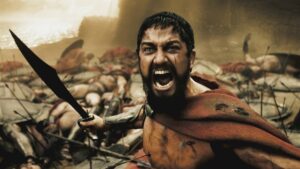 Leonidas (Gerard Butler) roars at Xerxes with a pile of bodies behind him in the movie 300.