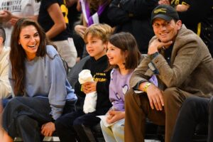 Mila Kunis and Ashton Kutcher and their children look on during the game between the Indiana Fever and Los Angeles Sparks on May 24 at the Crypto.com Arena in Los Angeles.