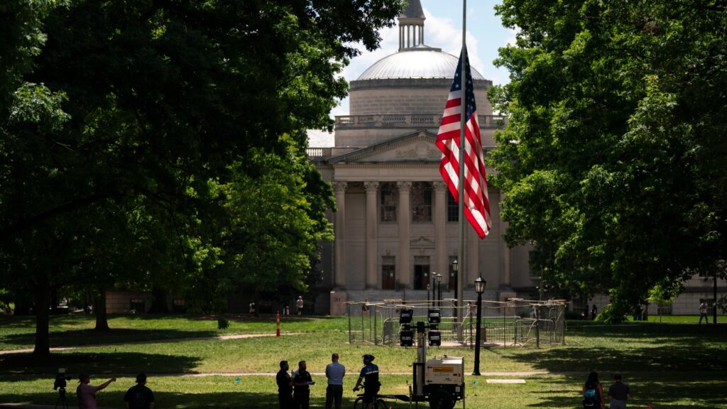 UNC Chapel Hill American Flag protected during protest by Pi Kappa Phi fraternity brothers