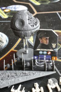 Y-Wings and X-Wings line up on a Executor-class Super Star Destroyer backed by a Death Star and TIE fighters. Admiral Piett looks on.