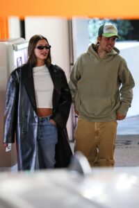 Hailey Bieber showed off her growing baby bump while her husband Justin flashed a huge smile during an outing in Los Angeles