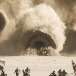 Sandworms on Arrakis emerge from a storm in Dune: Part Two with soldiers in front of them