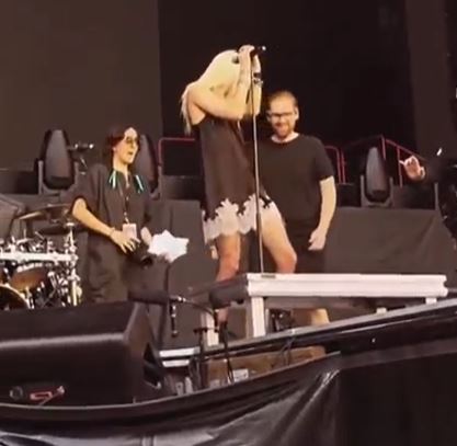 Staff rushed onto the stage to pull the bat off of her leg