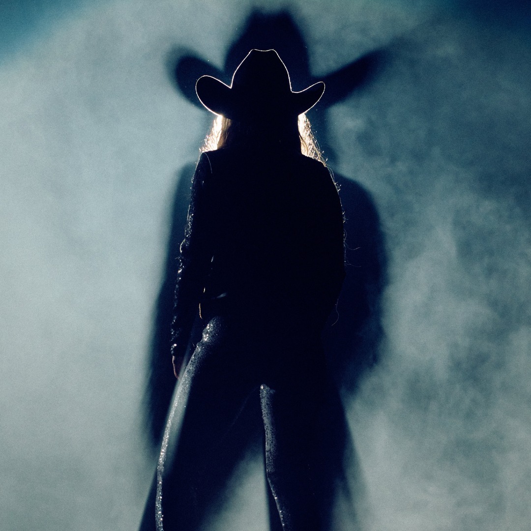 The entertainment company shared a shadow portrait of a singer wearing a cowboy hat and jacket