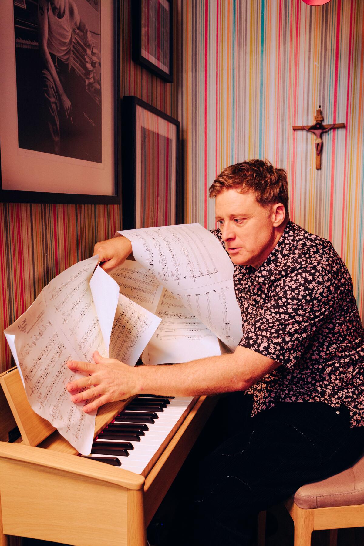 Alan Tudyk gets a little messy with the sheet music at his home piano.