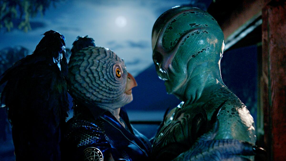 Two alien creatures stare lovingly at each other in a scene from "Resident Alien."