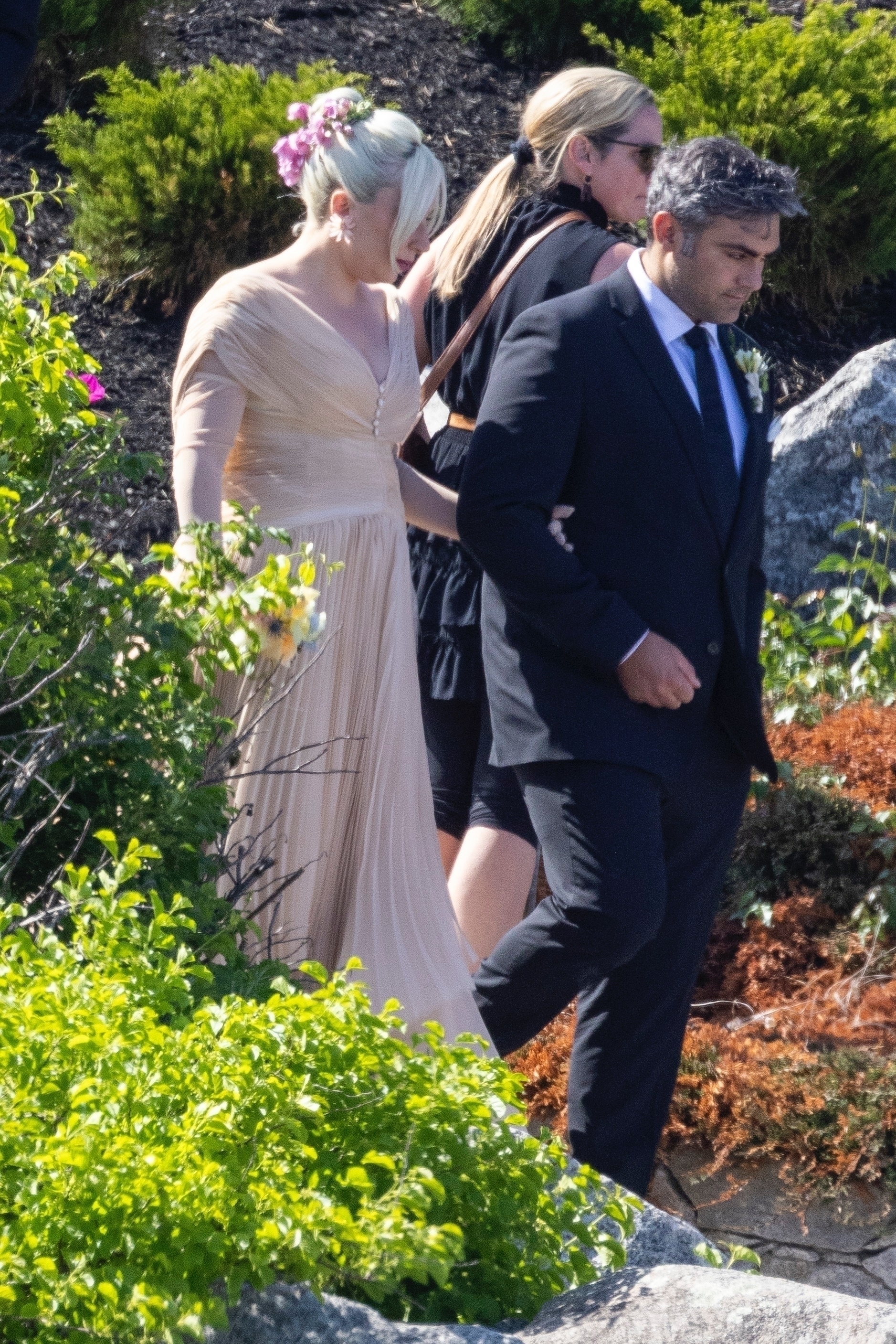 Gaga's beau wore a black tux with a flower attached to his jacket lapel