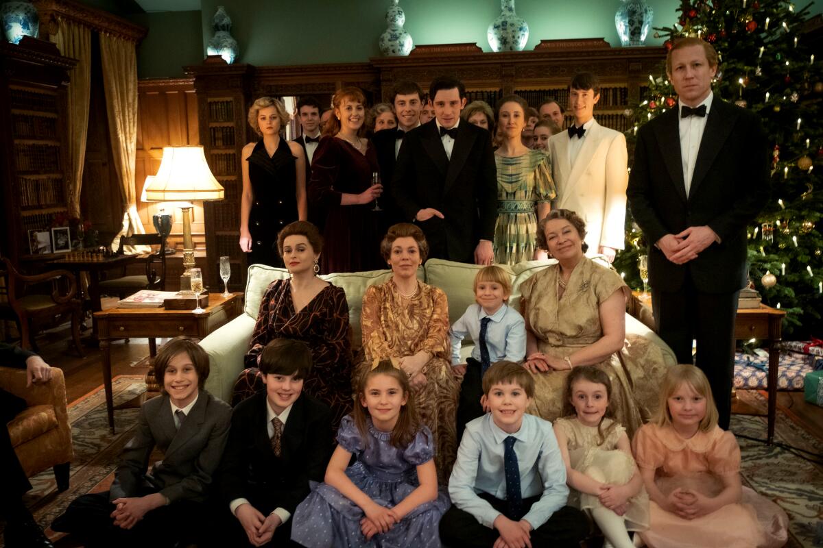 Children and adults pose for a family Christmas photo on "The Crown."