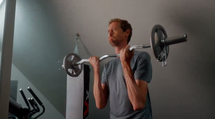 Crouchy can be seen performing EZ bar curls to target his biceps and brachialis