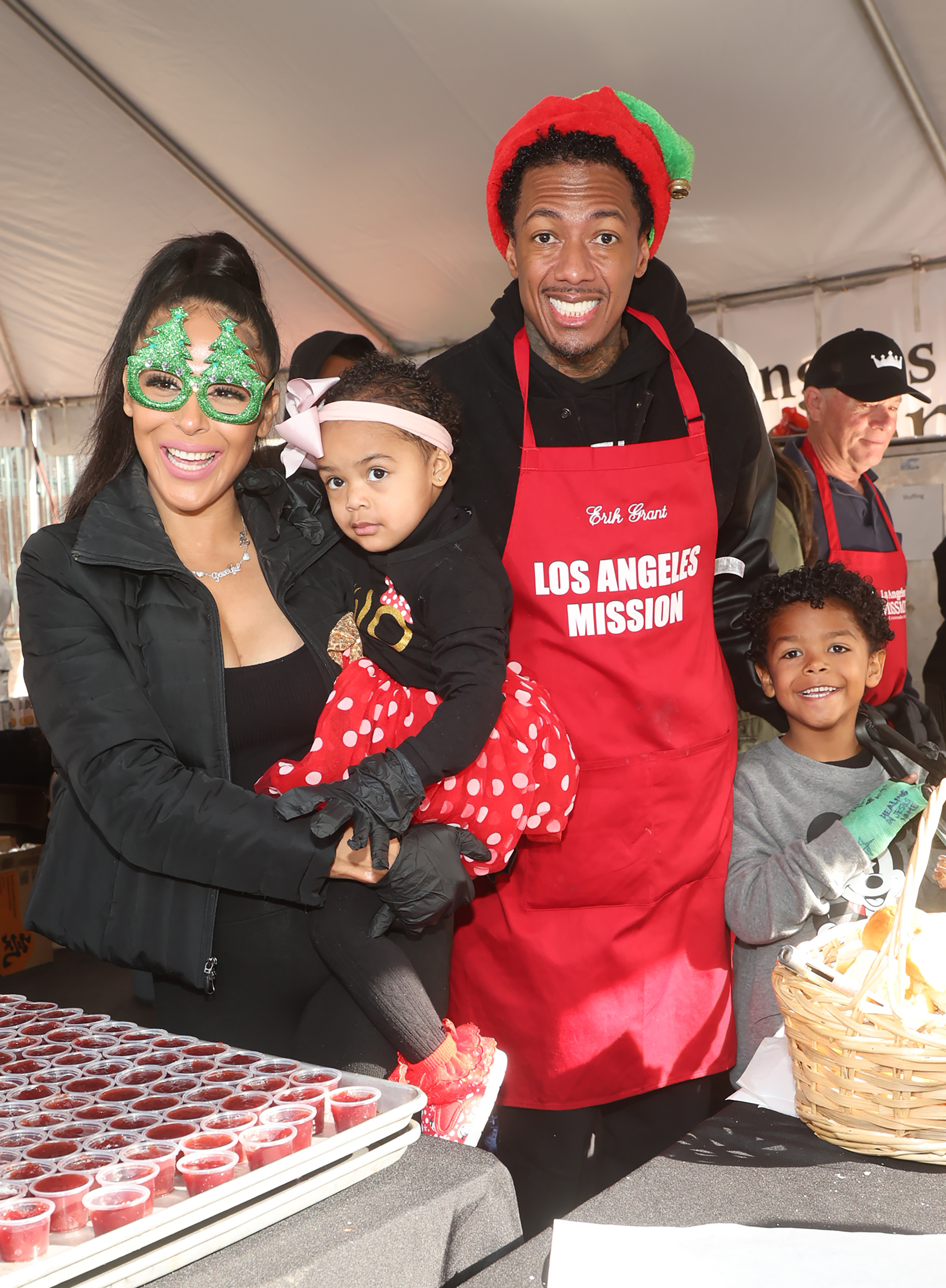 Nick Cannon and Brittany Bell with their children Golden and Powerful at Los Angeles Mission's Annual Christmas Feed-the-Homeless Event held at Samuel Goldwyn Theater