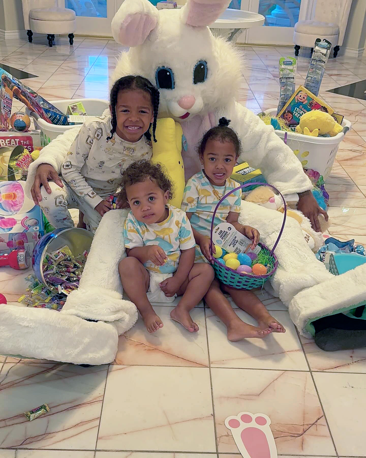 Nick Cannon dressed as an Easter Bunny with the three children he shares with Brittany Bell, Golden, Powerful, and Rise