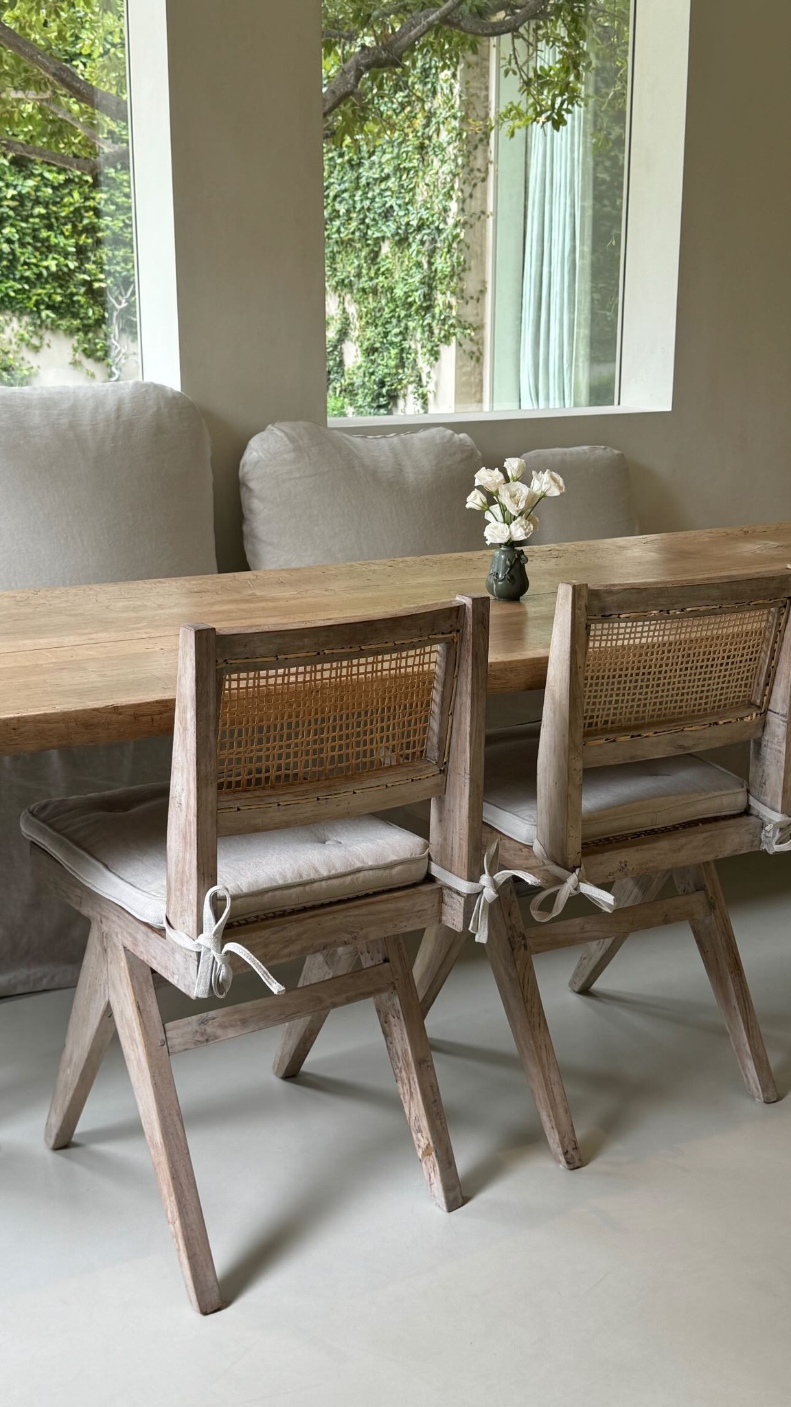 Kim uploaded a photo of the serene dining nook with its wooden chairs and small vase with white flowers