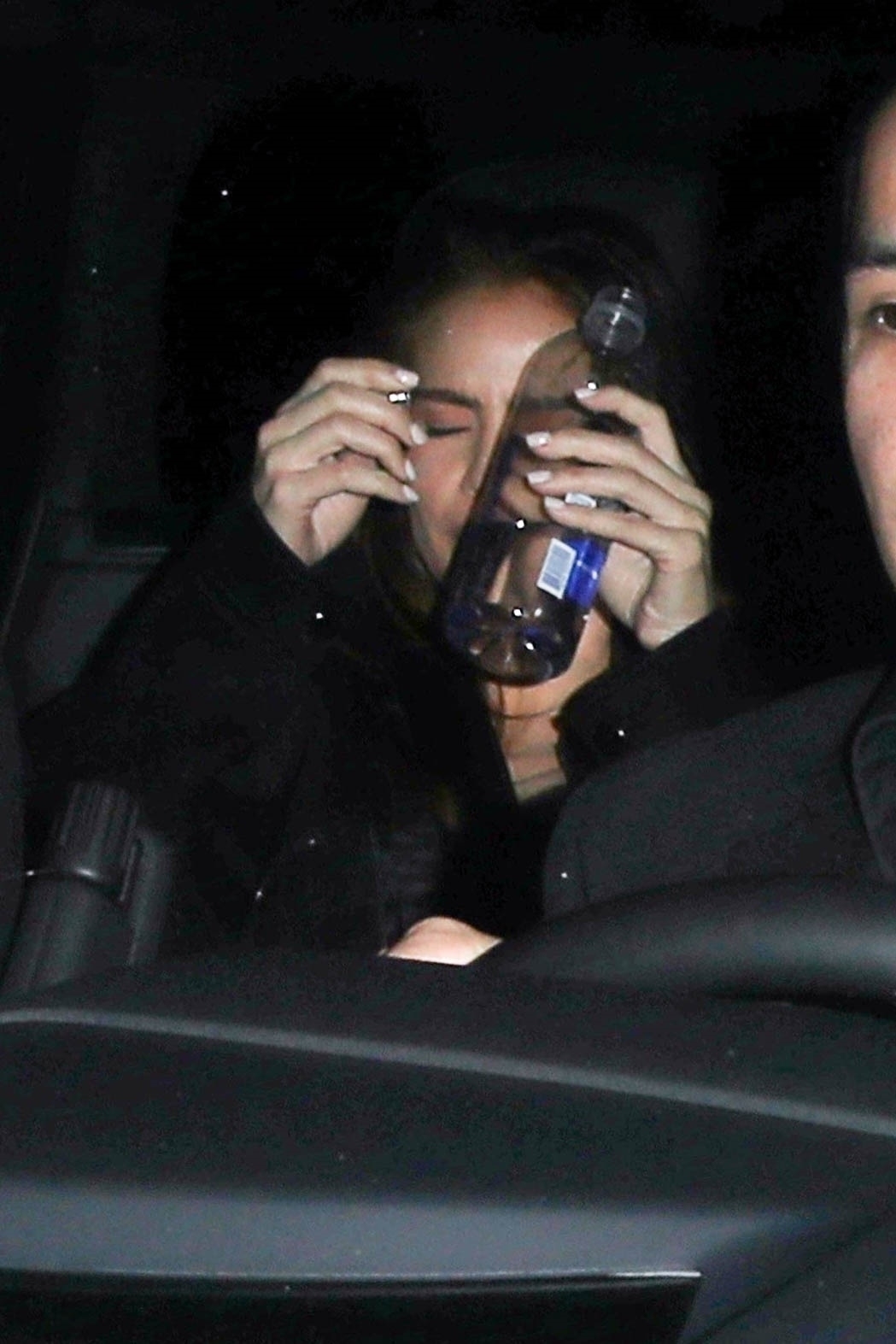 The woman shielded her face from cameras as they left Chateau Marmont Hotel