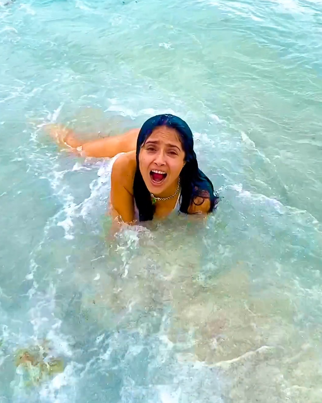 An Instagram video showed Salma being knocked over by waves
