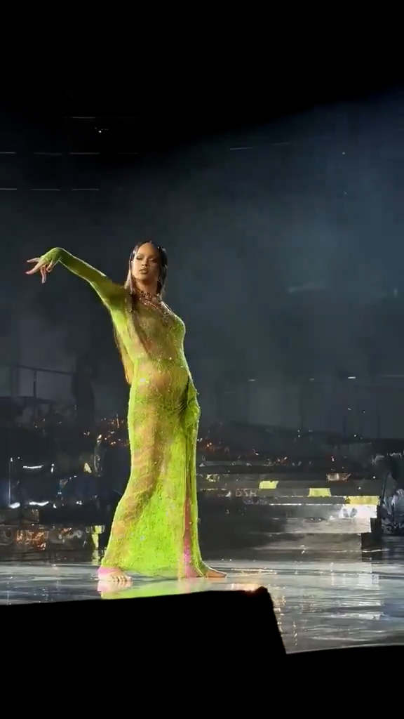 Some fans believed they saw a baby bump as Rihanna performed onstage in a tight green outfit for a pre-wedding party in India