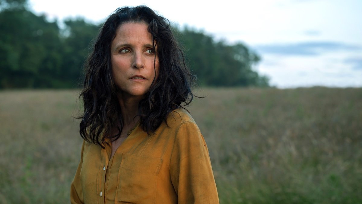 Julia Louis-Dreyfus in a yellow shirt in a field of green in Tuesday
