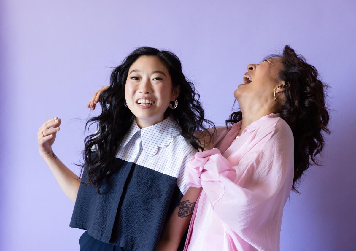 Awkwafina and Sandra Oh share a laugh during a portrait shoot.