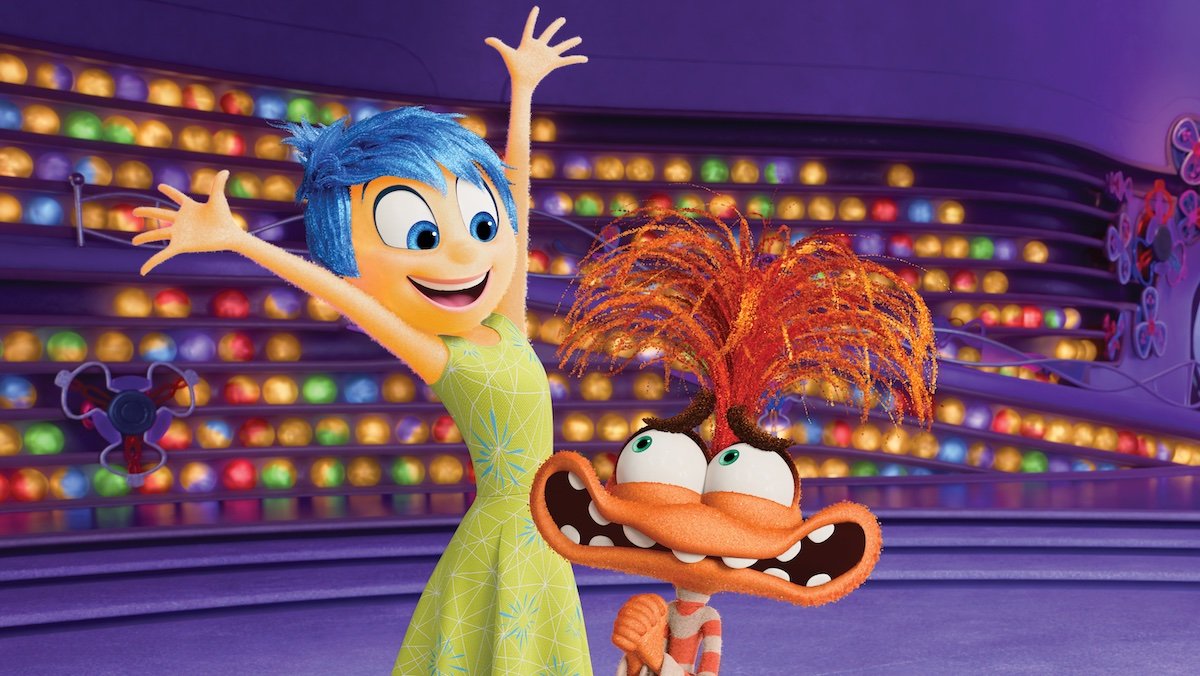 Joy holds her arms out wide to hug Anxiety in 
Inside Out 2