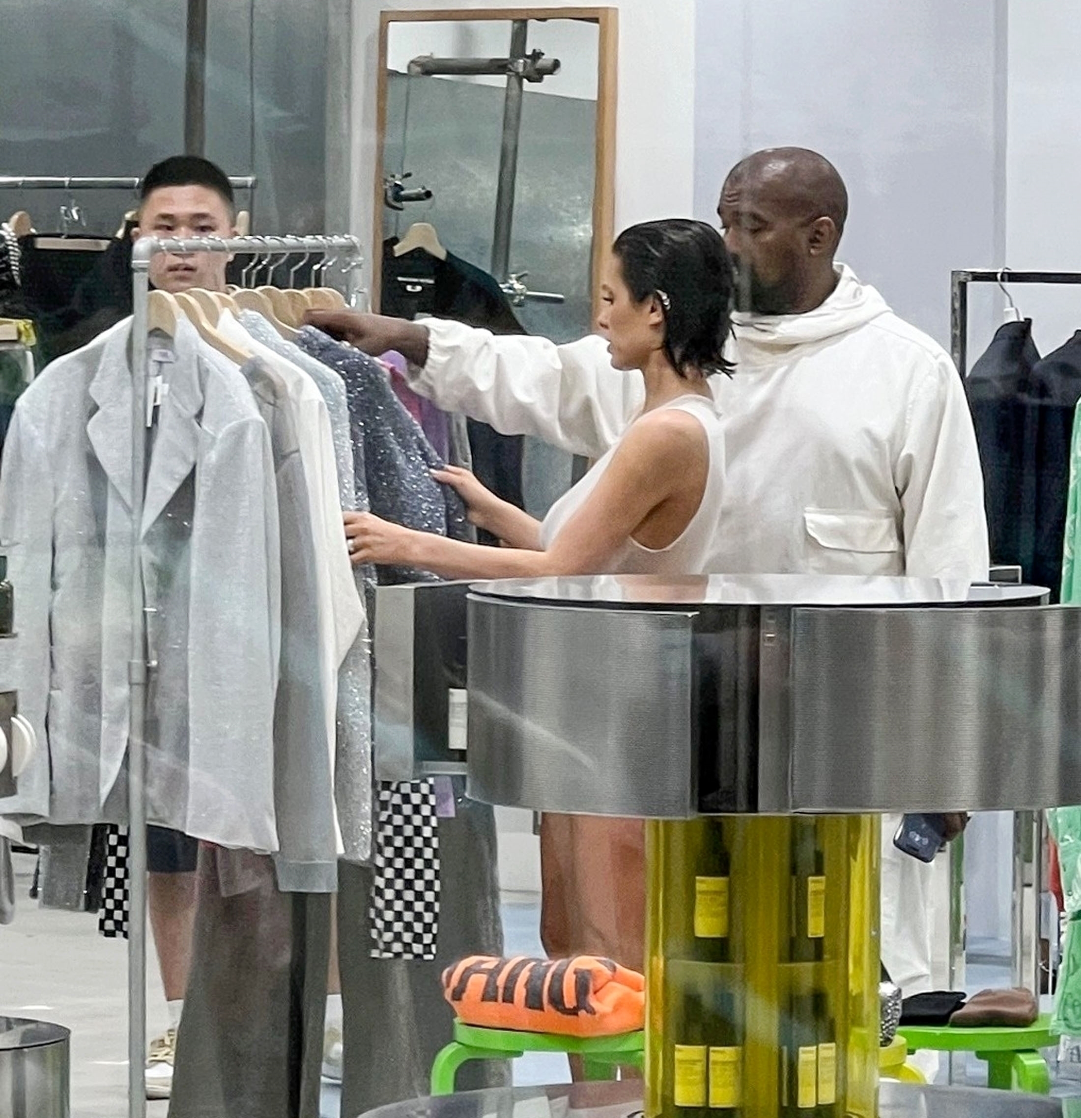 Kanye wore a more tame outfit as he covered up in a white tracksuit and sandals