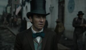 Tobias Menzies, in tophat and bowtie, in "Manhunt."