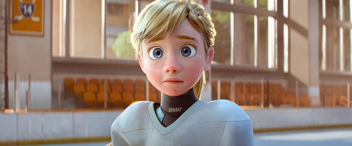 Inside Out’s Riley, now at age 13, stands in hockey gear on the ice of a rink, looking worried, in Pixar Animation Studio’s Inside Out 2