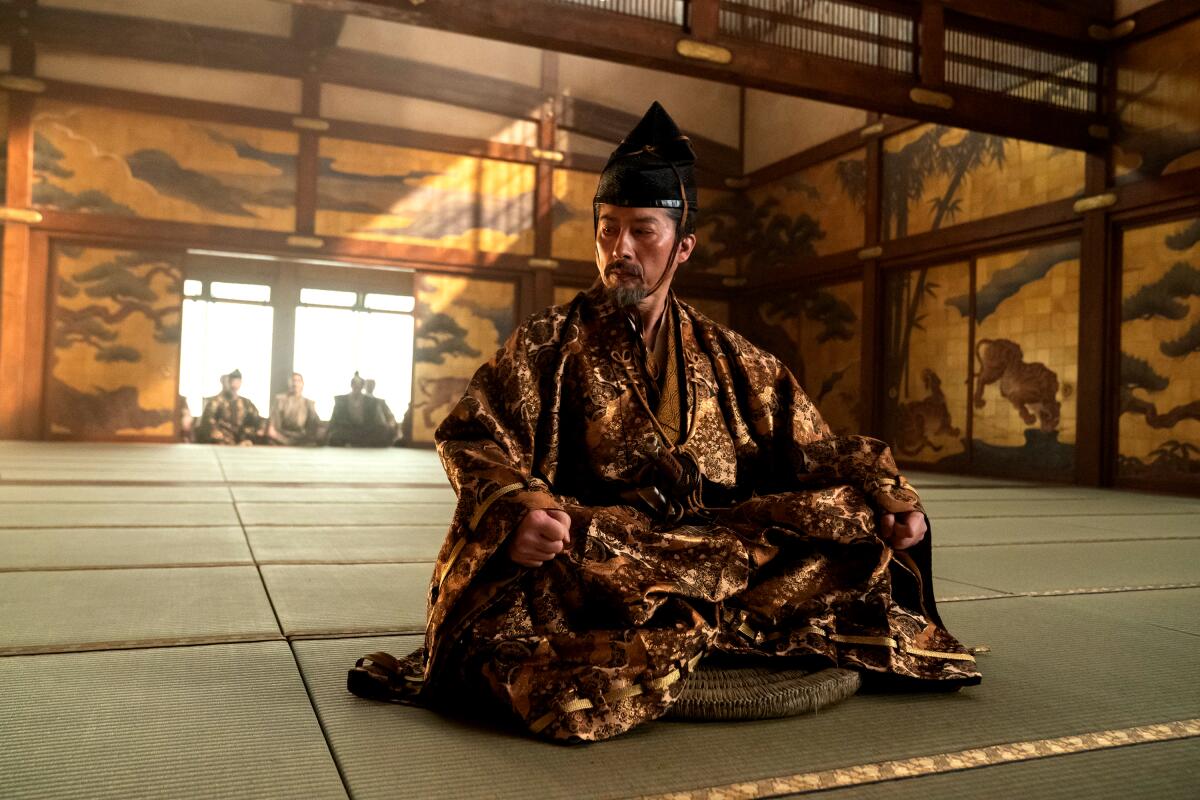 A man in 17th century Japanese dress sits on a mat in "Shogun."