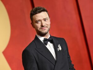 Justin Timberlake, wearing a tux, poses for a photo at the Vanity Fair Oscar Party.