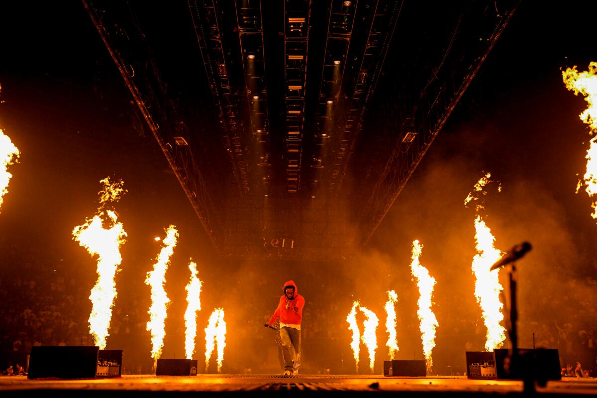 Kendrick on stage with pyro in the background