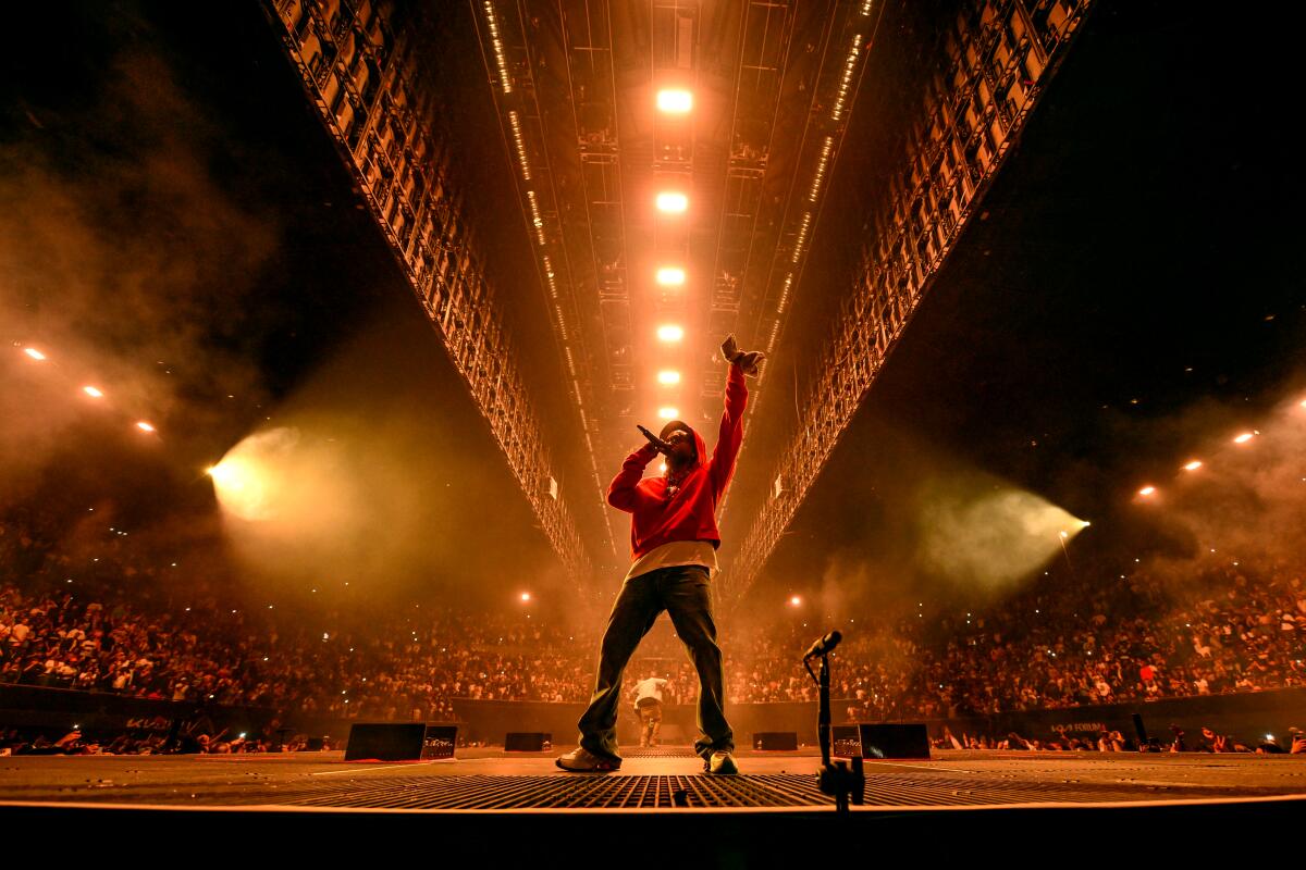 Kendrick on stage in red hoodie