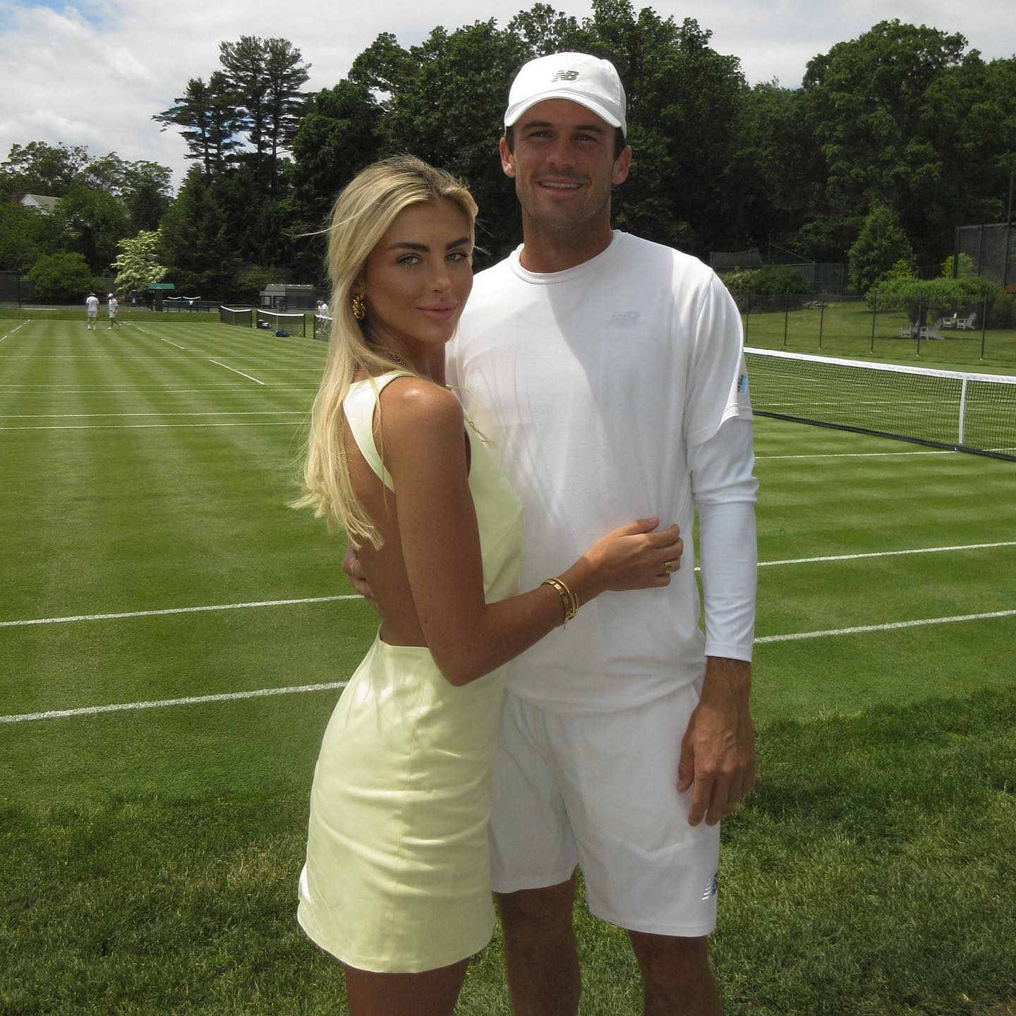 Tommy Paul and Paige Lorenze pose by some practice courts