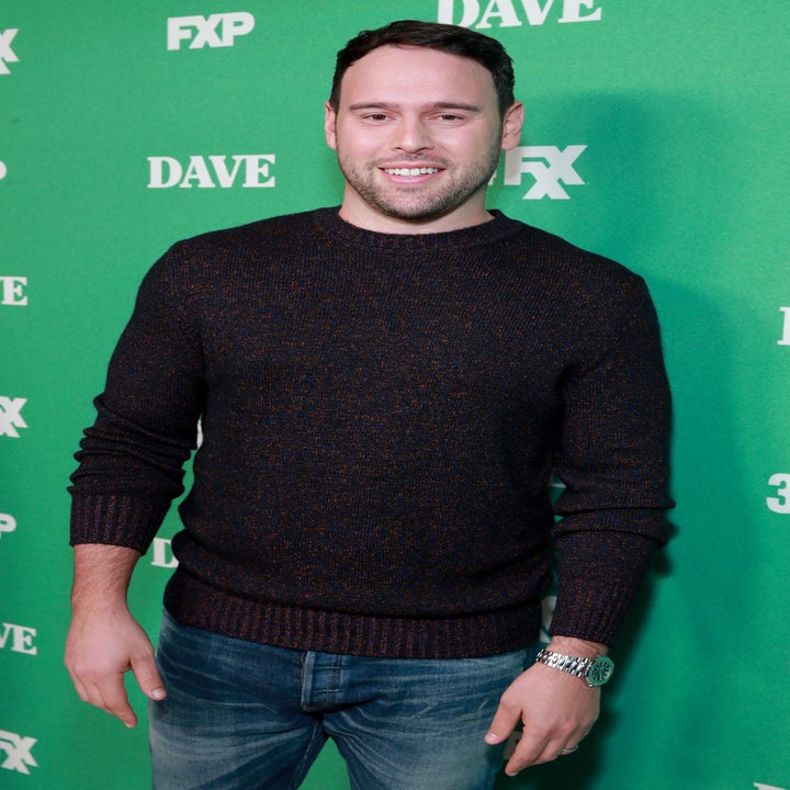 A man stands smiling in front of a green background with "FXP," "DAVE," and "FX" printed repeatedly in white text