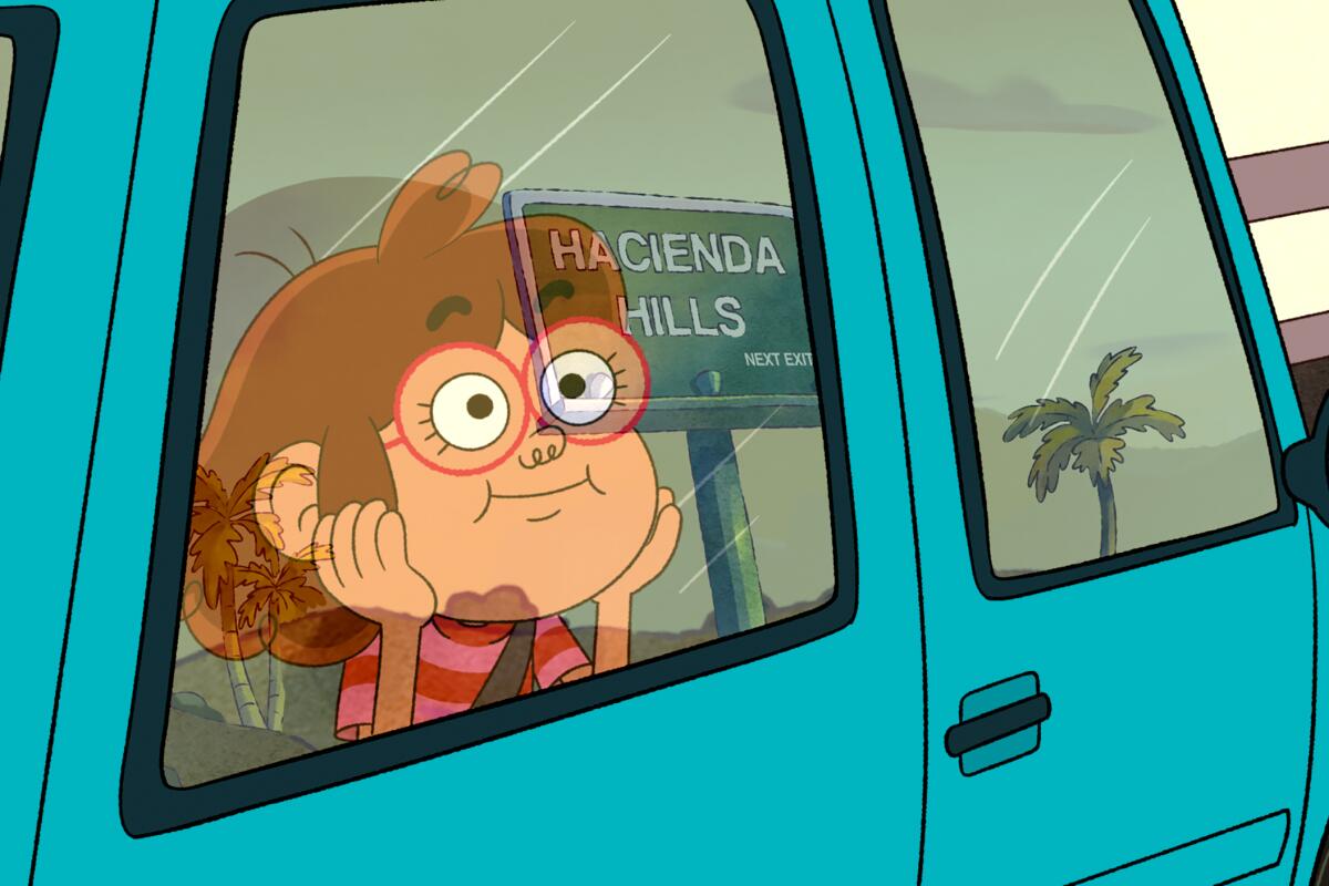 Tater looking at a Hacienda Hills sign from inside a car